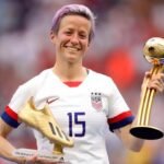 Megan Rapinoe smiling with his two awards