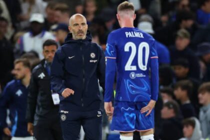 Cole Palmer clutching his groin while talking to Enzo Maresca