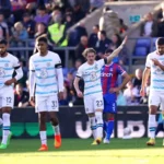 Chelsea players walk back after scoring a goal