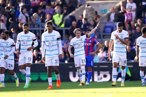 Chelsea players walk back after scoring a goal