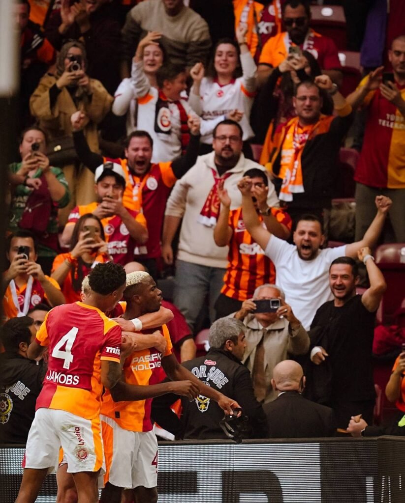 A photo of Victor Osimhen and his team mates celebrating in front of the fans