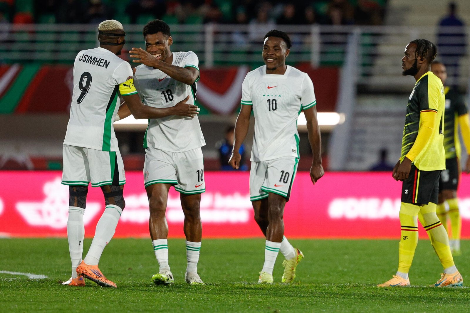 super eagles players celebrate a goal against uganda