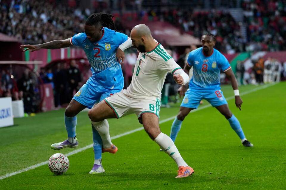 dr congo’s wan-bissaka and algeria’s abdelli challenge for the ball