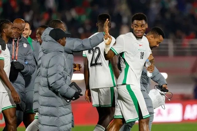 super eagles players celebrate a goal against uganda at afcon 2025