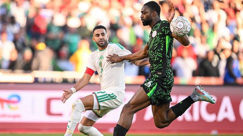 semi ajayi and riyad mahrez compete for the ball during the nigeria vs algeria clash