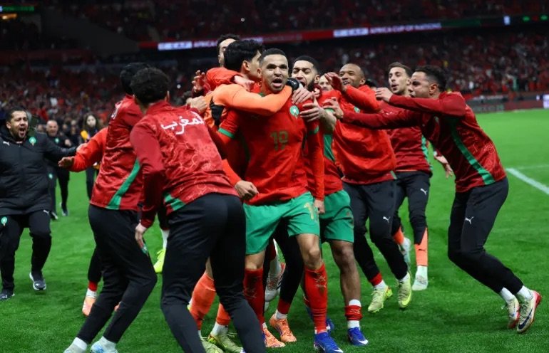 morocco players celebrate shootout win over nigeria