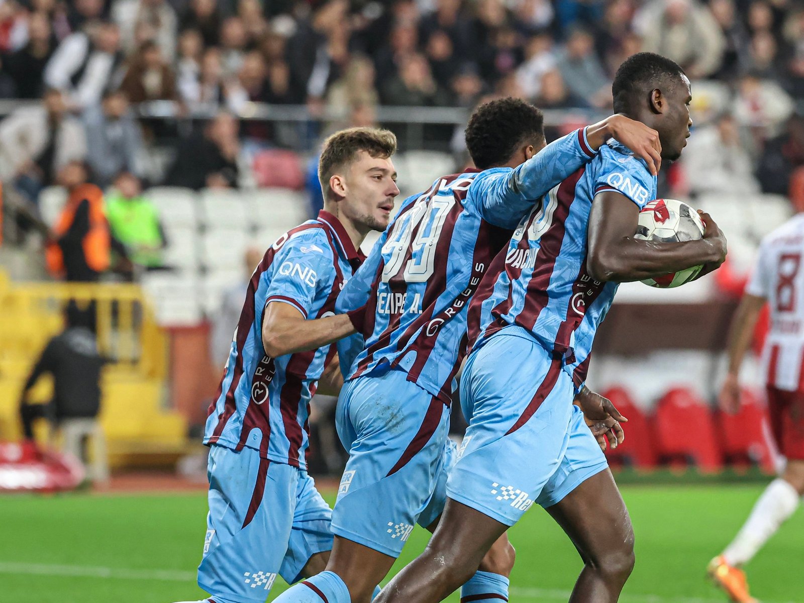 paul onuachu celebrates with his trabzonspor teammates after scoring a goal
