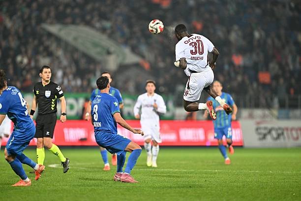 trabzonspor striker paul onuachu heads a ball during a turkish league game against rizespor