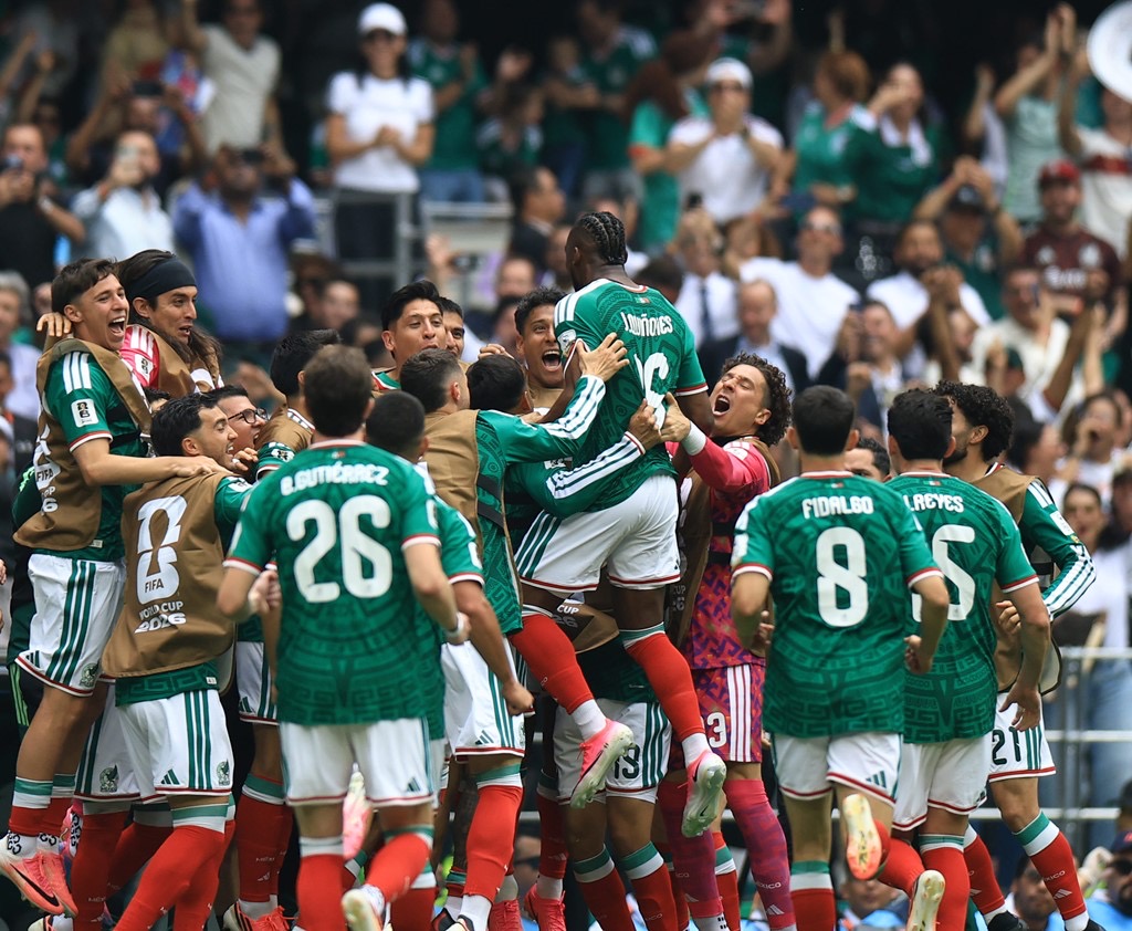 mexico players celebrate their opening goal at the 2026 world cup against south africa